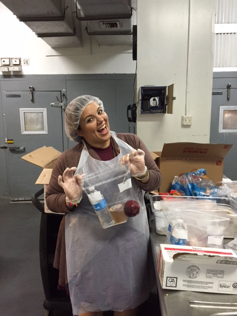 Woman packing lunch and smiling