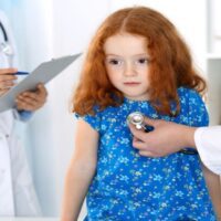 Doctor Examining a Little Girl with Stethoscope