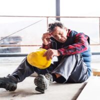 Male Worker at the Construction Site with Head and Neck Injury After an Accident