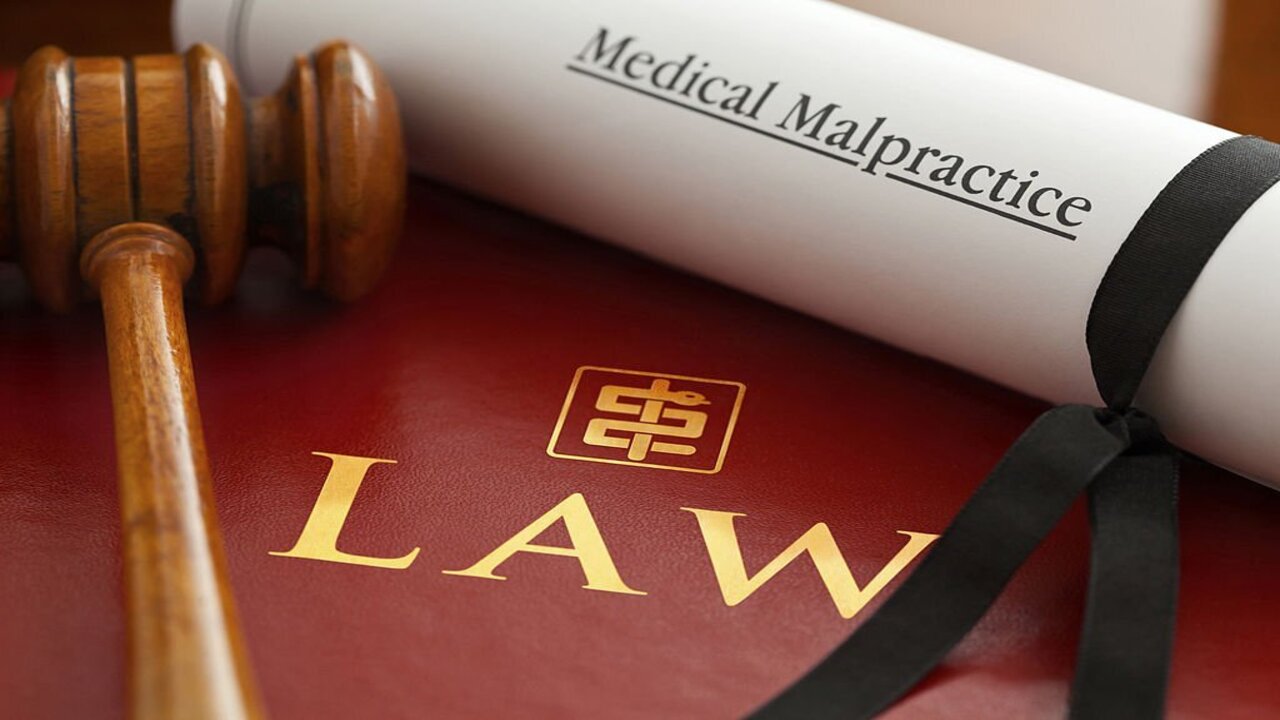 Red Leather Medical Law Book with Gold Embossed Type and Stylized Asclepius Logo