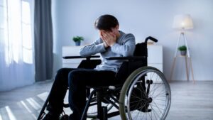 Teenager Covering His Face While Crying on His Wheelchair