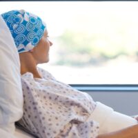 Woman with Cancer Lying on the Hospital Bed Feeling Worried About Her Condition While Looking at the Window