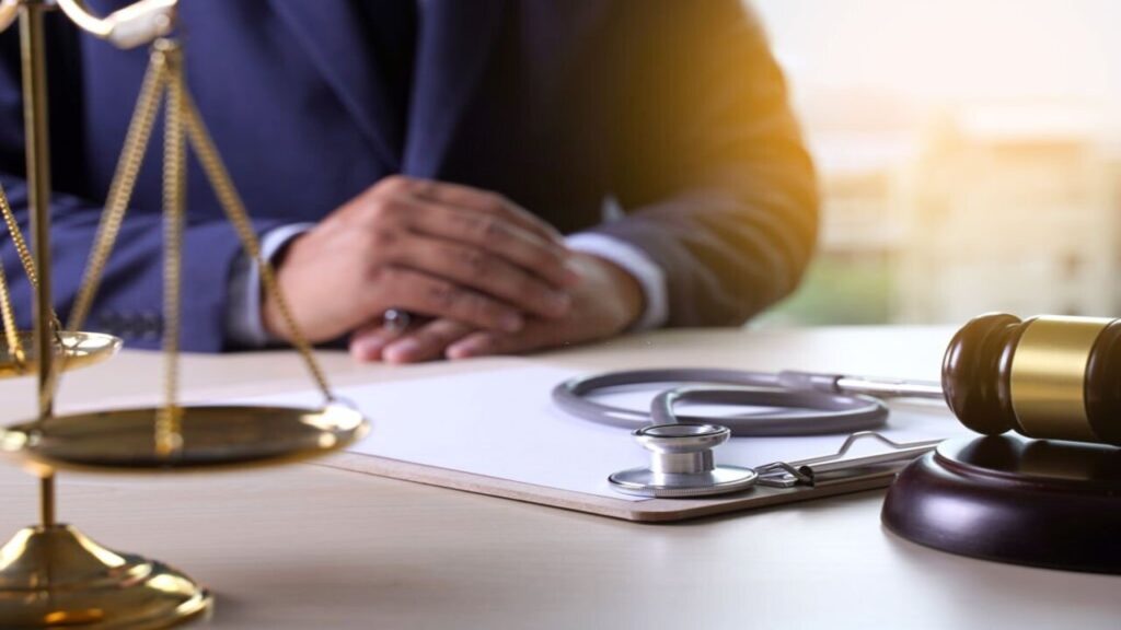 Lawyer Inside the Office with a Gavel and Stethoscope on His Desk