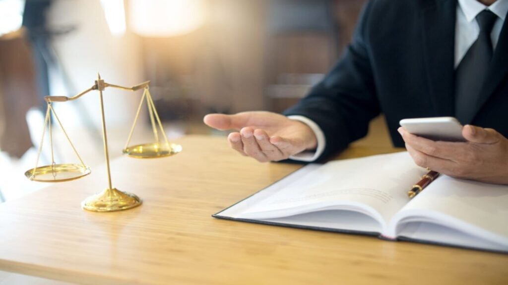 Lawyer Inside His Office Holding a Phone and a Paper on His Desk